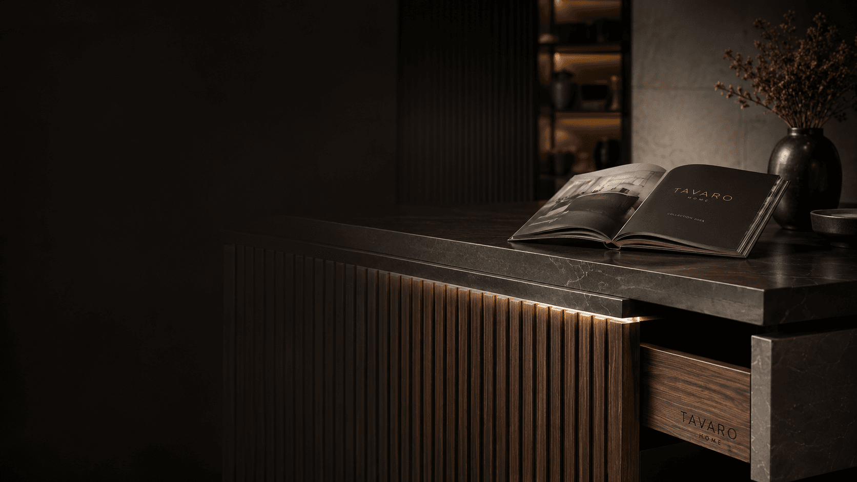 Detail of a furniture built-in with fluted wood, a stone worktop and an open TAVARO catalogue