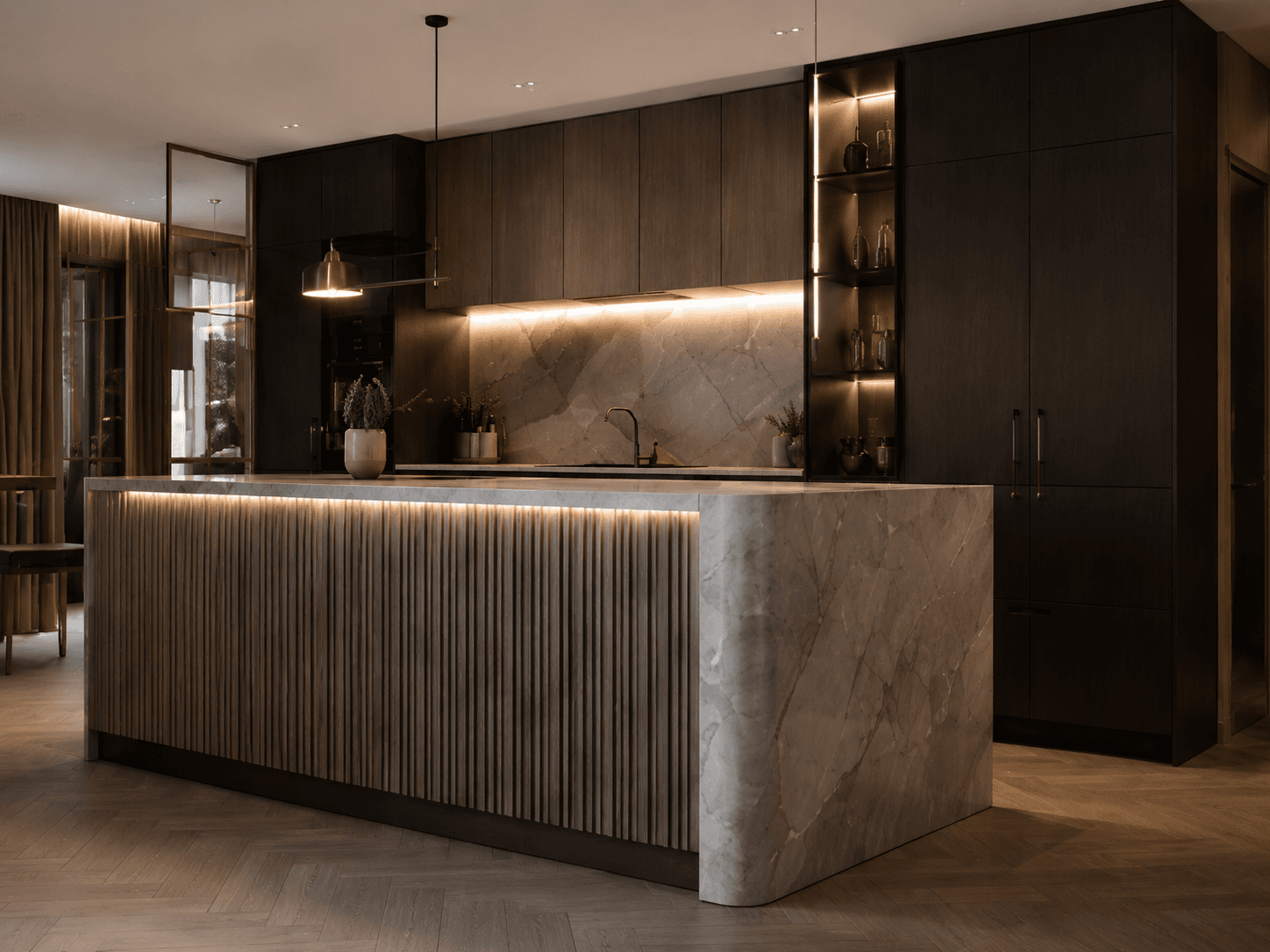 Custom-made kitchen with dark built-ins, a stone island and warm lighting